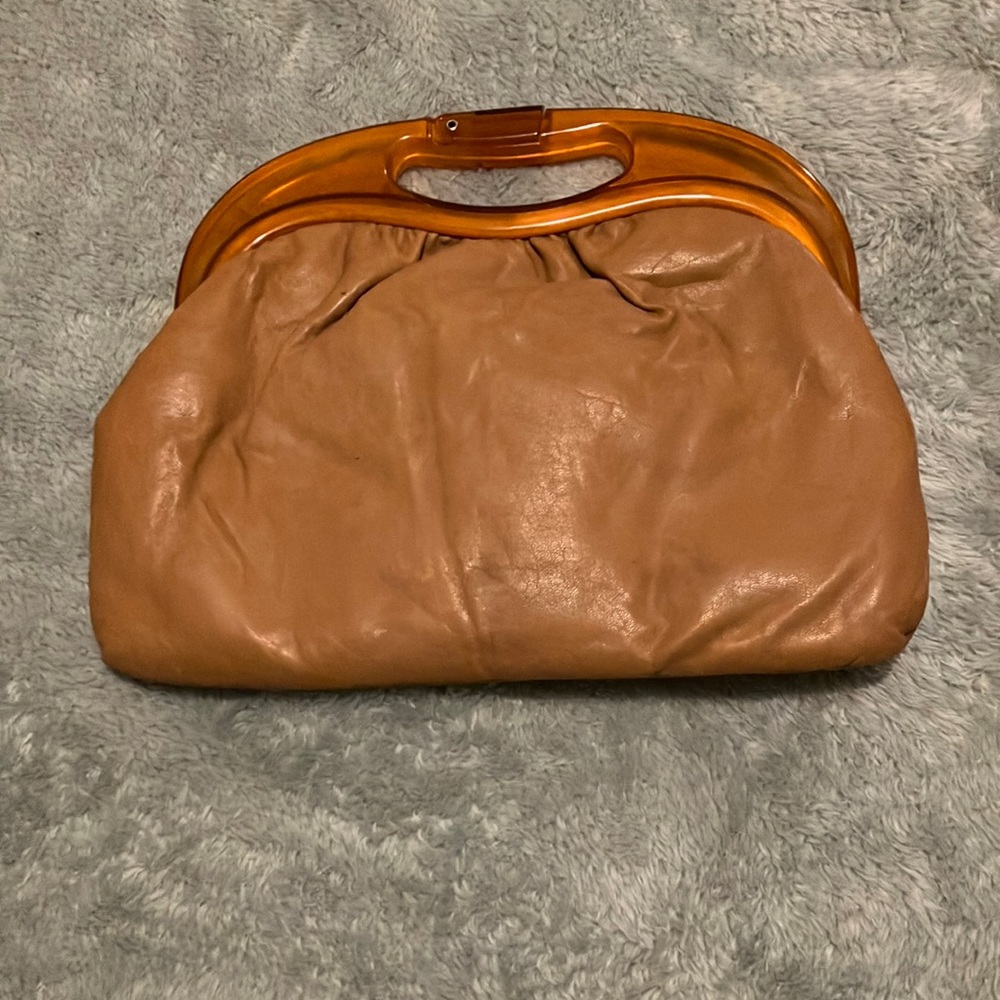 Ward’s faux leather brown clutch with amber plastic handle